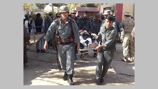 Policemen Carry the Body of a Civilian After a Bomb Blast in Faryab rovince