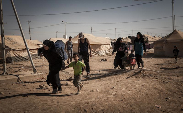 Syrian refugees carry their belongings to their tent after arriving at Za'atari refugee camp, Jordan.