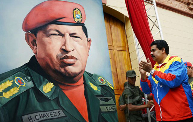 Maduro, in Chavez's typical tricolor tracksuit, praising a painting of Hugo Chavez