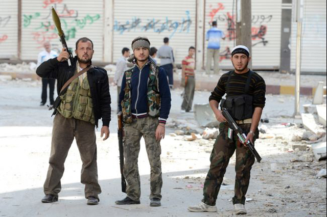 Armed rebel fighters at the front line as they battle pro-government Syrian troops. (Getty Images)