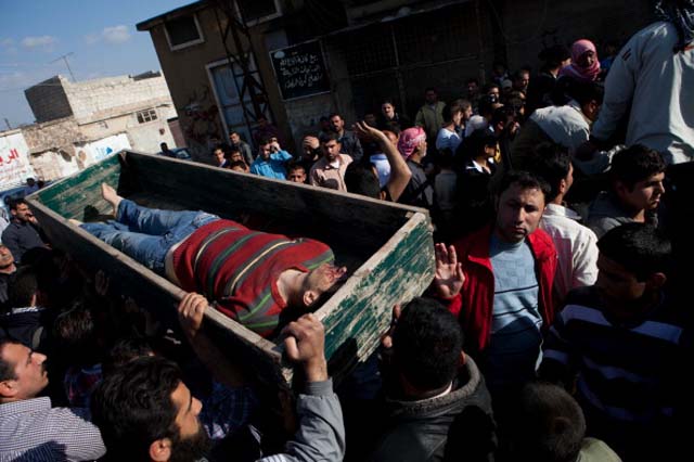 Neighbors and relatives carry the coffin of 20-year-old rebel of the Free Syria Army (FSA) during his funeral (AFP/GettyImages)