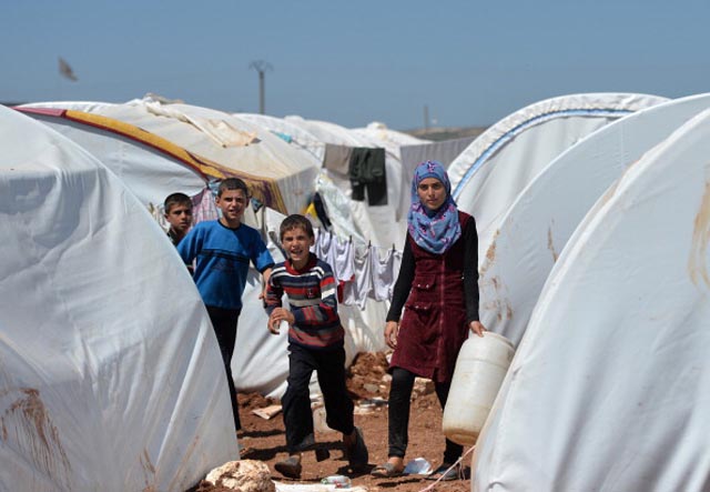Refugees internally displaced  at the Maiber al-Salam refugee camp along the Turkish border  (Getty Images)