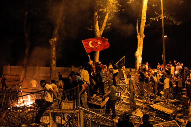 Protestors clash with riot police between Taksim and Besiktas in Istanbul, on June 1, 2013, during a demonstration against the demolition of the park. Turkish police on June 1 began pulling out of Istanbul's iconic Taksim Square, after a second day of violent clashes between protesters and police over a controversial development project. Thousands of demonstrators flooded the site as police lifted the barricades around the park and began withdrawing from the square. What started as an outcry against a local development project has snowballed into 