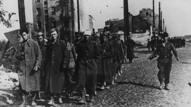 1st October 1944:  The end of Warsaw's uprising sees a group of city defenders marched off to prison camps by their German captors.  (Getty Images)