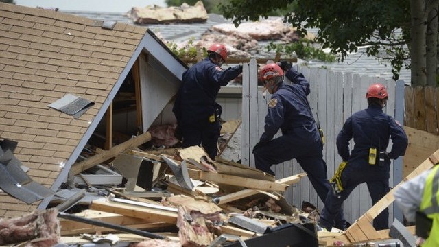 Emergency responders sift through debris. (Getty Images)
