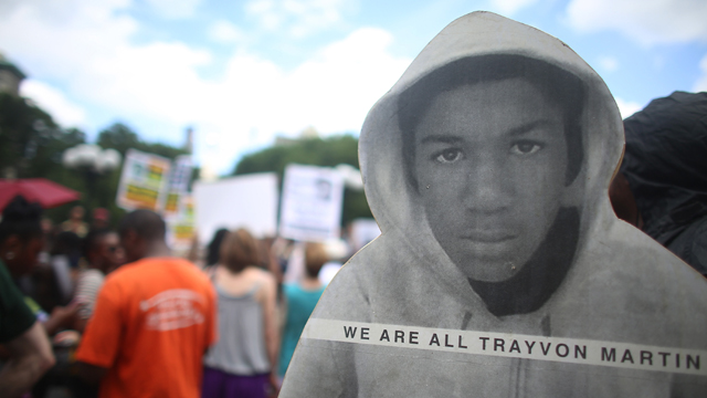 People gather at a rally honoring Trayvon Martin with his photo. (Getty Images)
