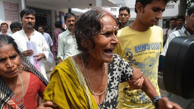 A woman grieves at the news of the deaths (Image courtesy of Twitter)
