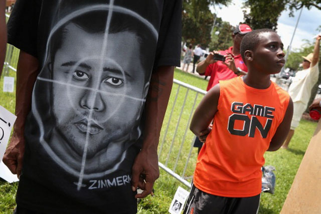 A demonstrator wears a shirt with a picture of George Zimmerman as a target during a protest in front of the Seminole County Criminal Justice Center  (Getty Images)