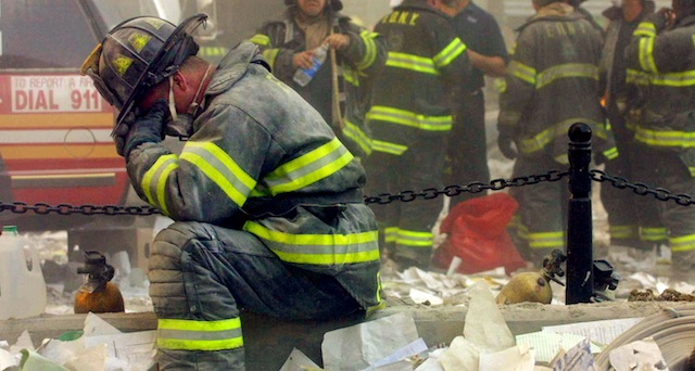 A first responder takes a moment in lower Manhattan on September 11, 2001. (Getty)