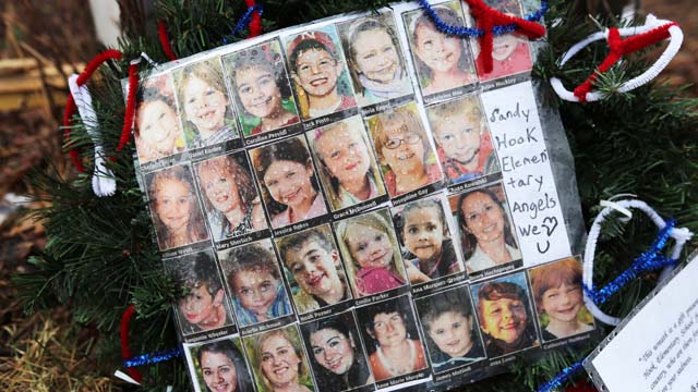 Photos of Sandy Hook Elementary School massacre victims are seen at a memorial near the school on January 14, 2013, in Newtown, Connecticut. Twenty-six children and adults at the school lost their lives on December 14, 2012, in one of the worst shooting tragedies in U.S. history. (Getty)