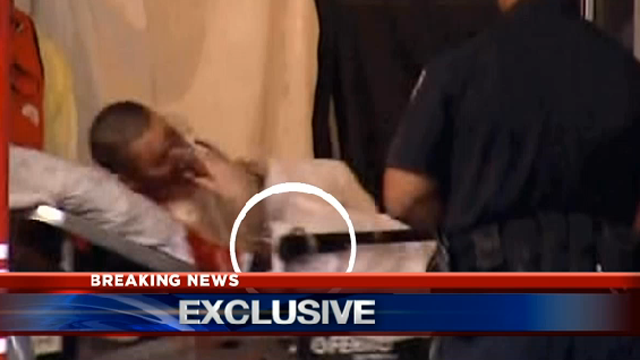 CAL has uncovered within their footage this image of an injured man who appears to be handcuffed to the gurney. (KCAL screenshot)