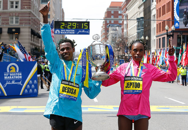 Women's champion Rita Jeptoo of of Kenya and men's champion Lelisa Desisa Benti of Ethiopia at the 2013 marathon. (Getty)