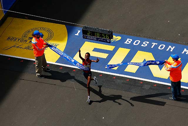 Rita Jeptoo crosses the finish line. (Getty)
