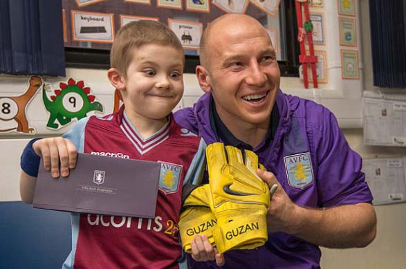 Brad Guzman gives his gloves to Jamie Morris, a 7-year- old cancer survivor. 