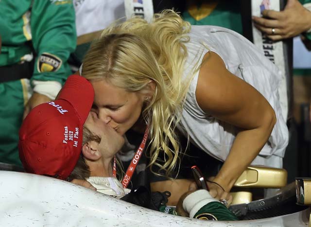 Ed Carpenter gets a kiss from his wife, Heather, during the IZOD IndyCarSeries MATV 500 World Championship at Auto Club Speedway. (Getty)