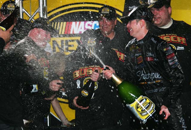 Kurt Busch sprays team members with champagne after a victory in the Spring Series. (Getty)