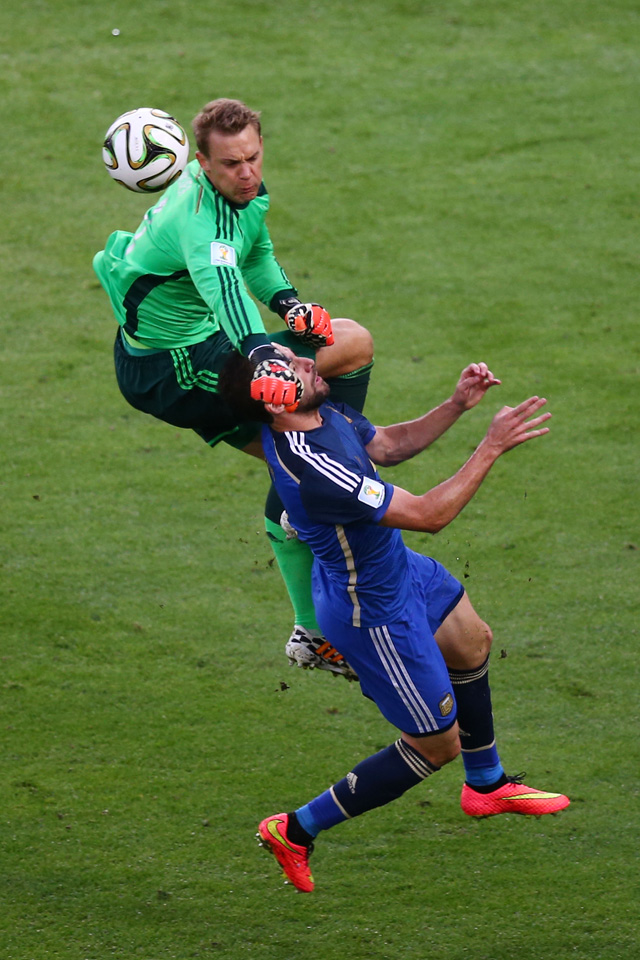 Manuel Neuer of Germany collides with Gonzalo Higuain