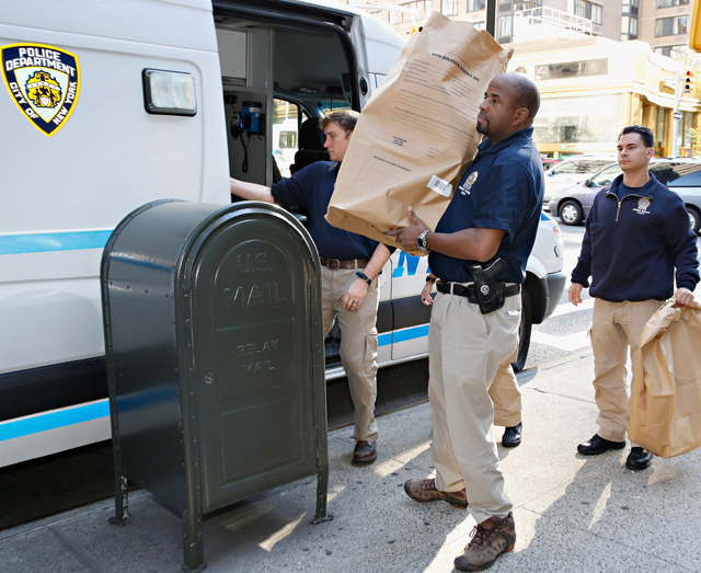 (Getty - NYPD Crime Scene Unit officers are seen holding biological evidence bags outside attorney Sanford Rubenstein's apartment building on October 6, 2014)