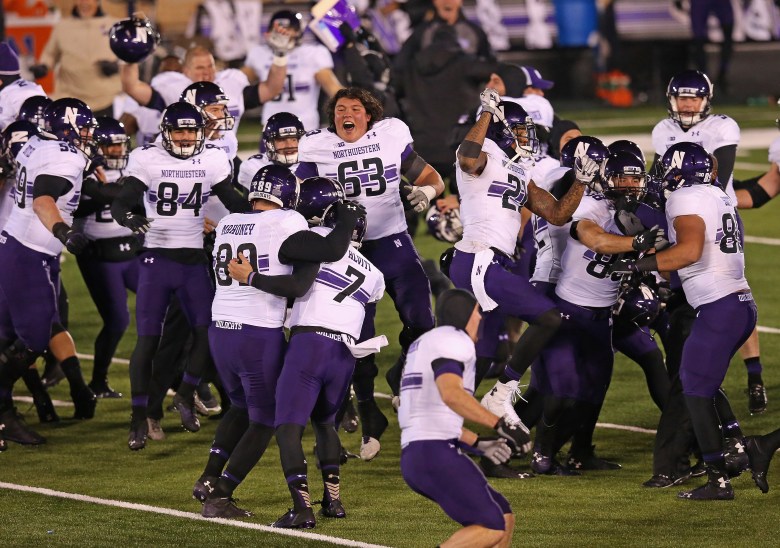 Northwestern players celebrate their 43-40 overtime win over Notre Dame on Saturday. (Getty)