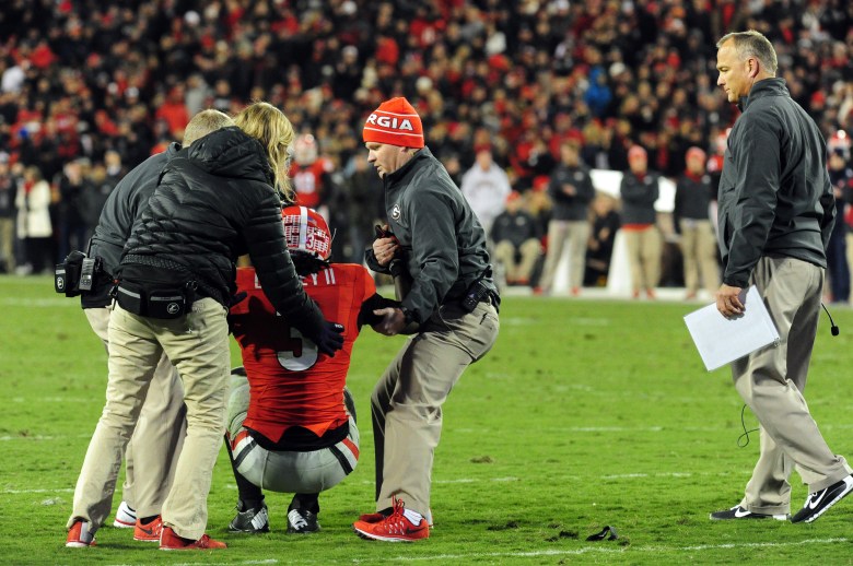 Georgia running back Todd Gurley is helped up after injuring his left knee Saturday. Gurley tore his ACL and is out for the season. (Getty)