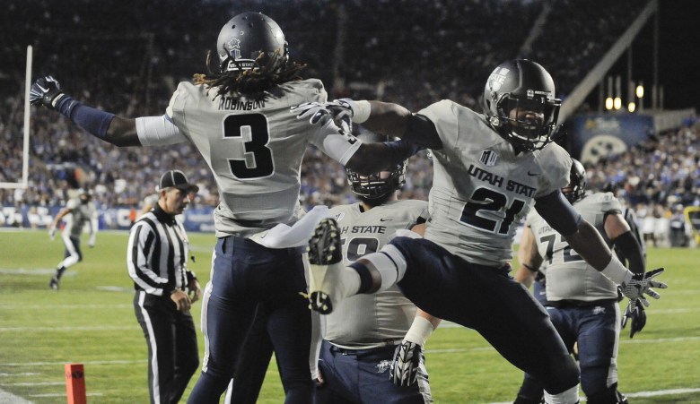 Devonte Robinson (3) and LaJuan Hunt celebrate a touchdown in Utah State's win over BYU earlier this season. (Getty)