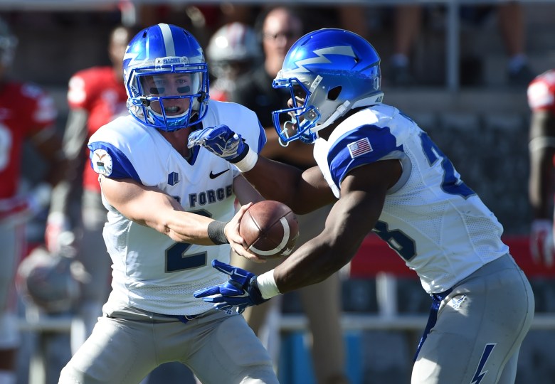 Air Force quarterback Kale Pearson hands the ball off to running back Jacobi Owens earlier in the season. (Getty)