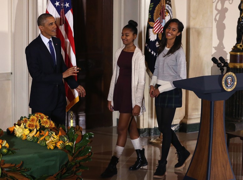 Sasha and Malia look on as President Barack Obama speaks after pardoning "Cheese" and his alternate Mac, during a ceremony at  the White House. (Getty)