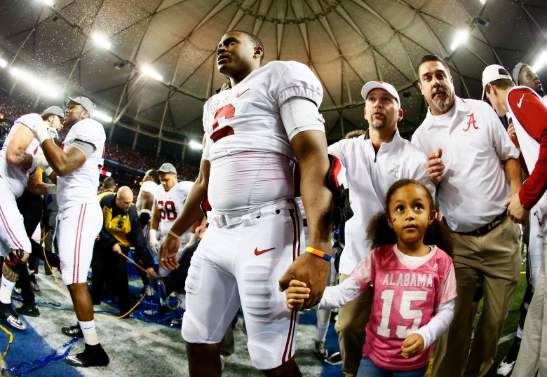 Alabama quarterback Blake Sims and his daughter Kyla after the SEC Championship Game in December. (Getty)
