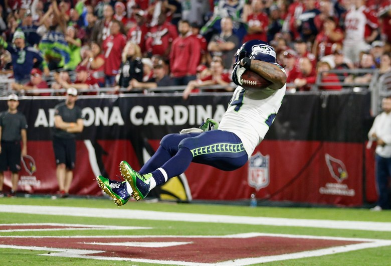 Seahawks running back Marshawn Lynch leaps into the end zone for a score earlier this season vs. Arizona. (Getty)
