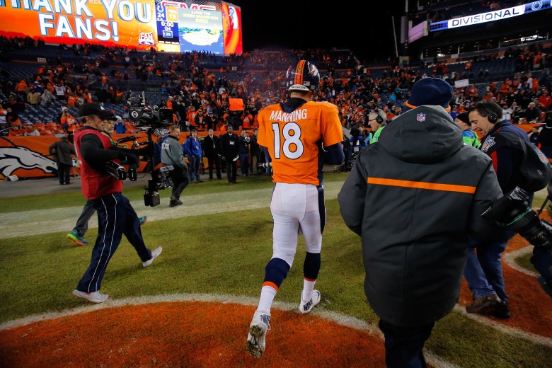 Peyton Manning jogs off the field after his Broncos lost 24-13 to the Colts in Sunday's playoff game. (Getty)