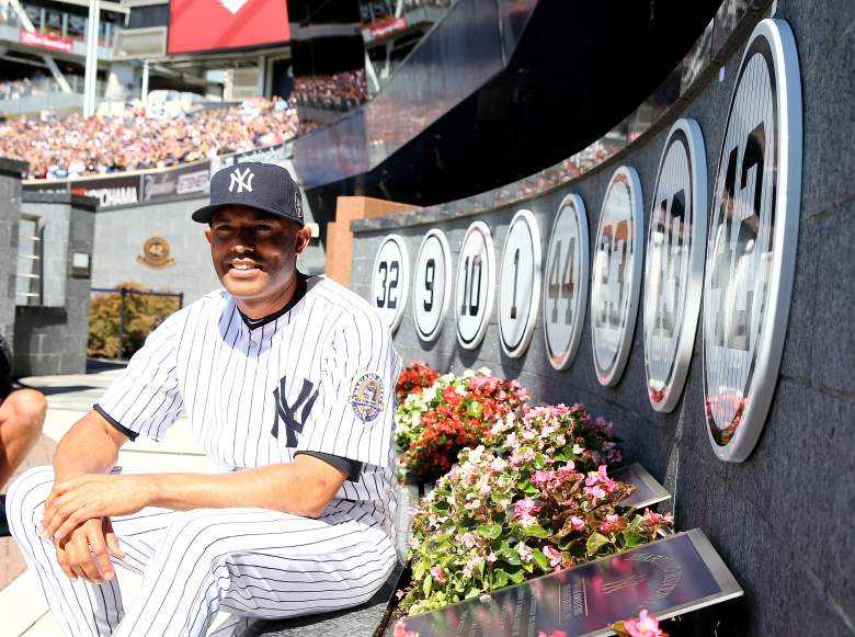 Mariano Rivera posing next to retired numbers in Monument Park (located beyond the center field wall at Yankee Stadium). (Getty)