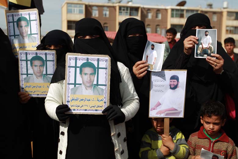 Relatives of Yemeni inmates held in the US detention center 'Camp Delta' at the US Naval Base in Guantanamo Bay, Cuba, brandish their portraits during a protest to demand their release, outside the American Embassy in the capital Sanaa, on January 11, 2014. (Getty)