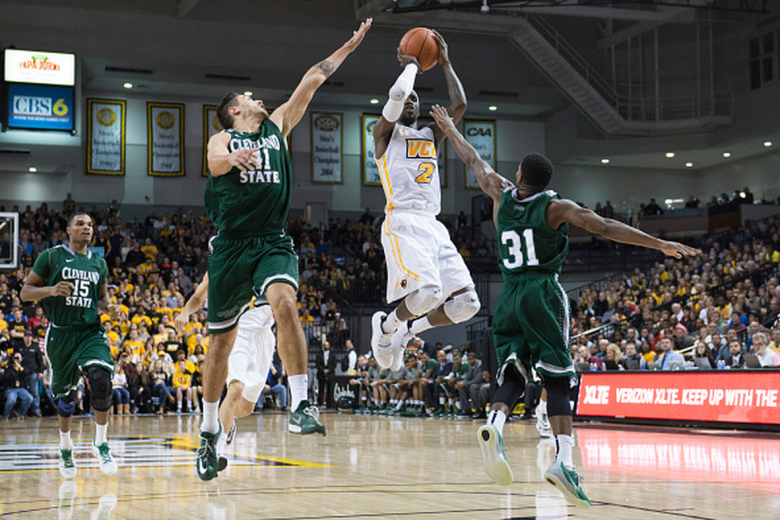 Briante Weber of the Virginia Commonwealth Rams shoots as Vinny Zollo  and Charlie Lee of the Cleveland State Vikings defends during the second half at the Siegel Center on December 29, 2014 in Richmond,  Virginia. (Getty)