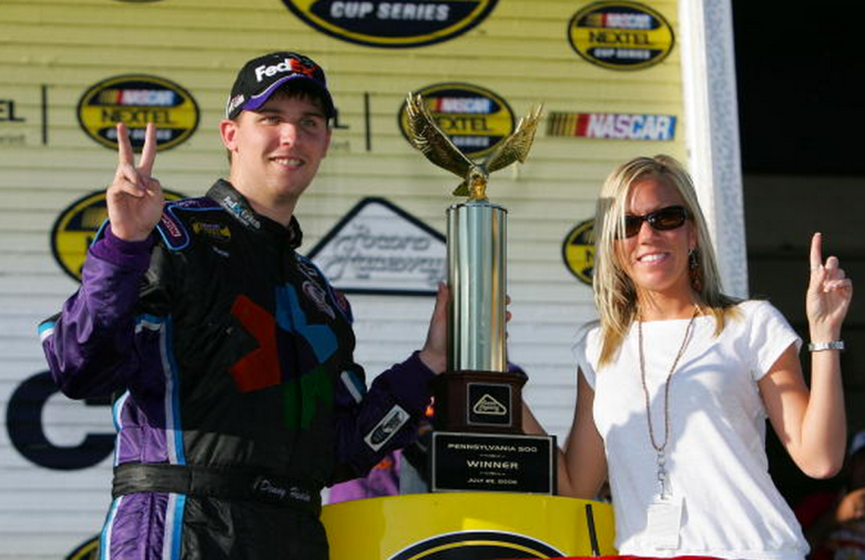 Denny Hamlin, driver of the #11 FedEx Kinko's Chevrolet, celebrates his win with girlfriend Kristin Buntain in victory lane following the NASCAR Nextel Cup Series Pennsylvania 500 on July 23, 2006 at Pocono Raceway in Long Pond, Pennsylvania. (Getty)