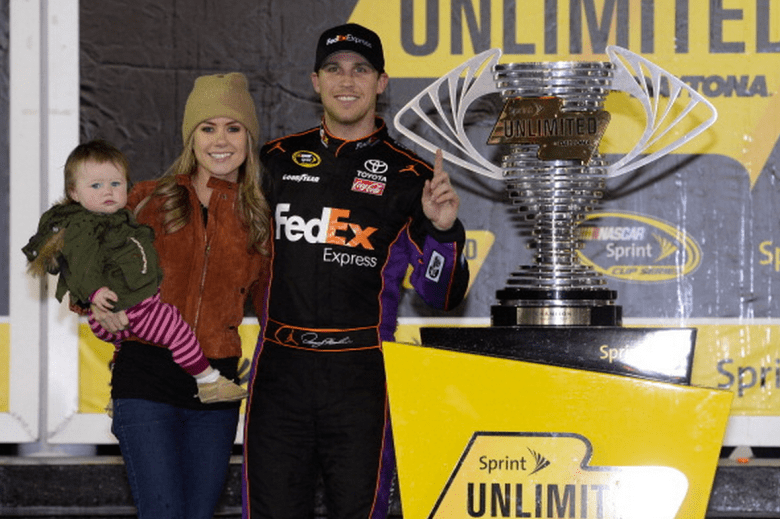 Denny Hamlin, driver of the #11 FedEx Express Toyota, celebrates in victory lane with Jordan Fish and daughter Taylor during the NASCAR Sprint Cup Series Sprint Unlimited at Daytona International Speedway on February 15, 2014 in Daytona Beach, Florida. (Getty)