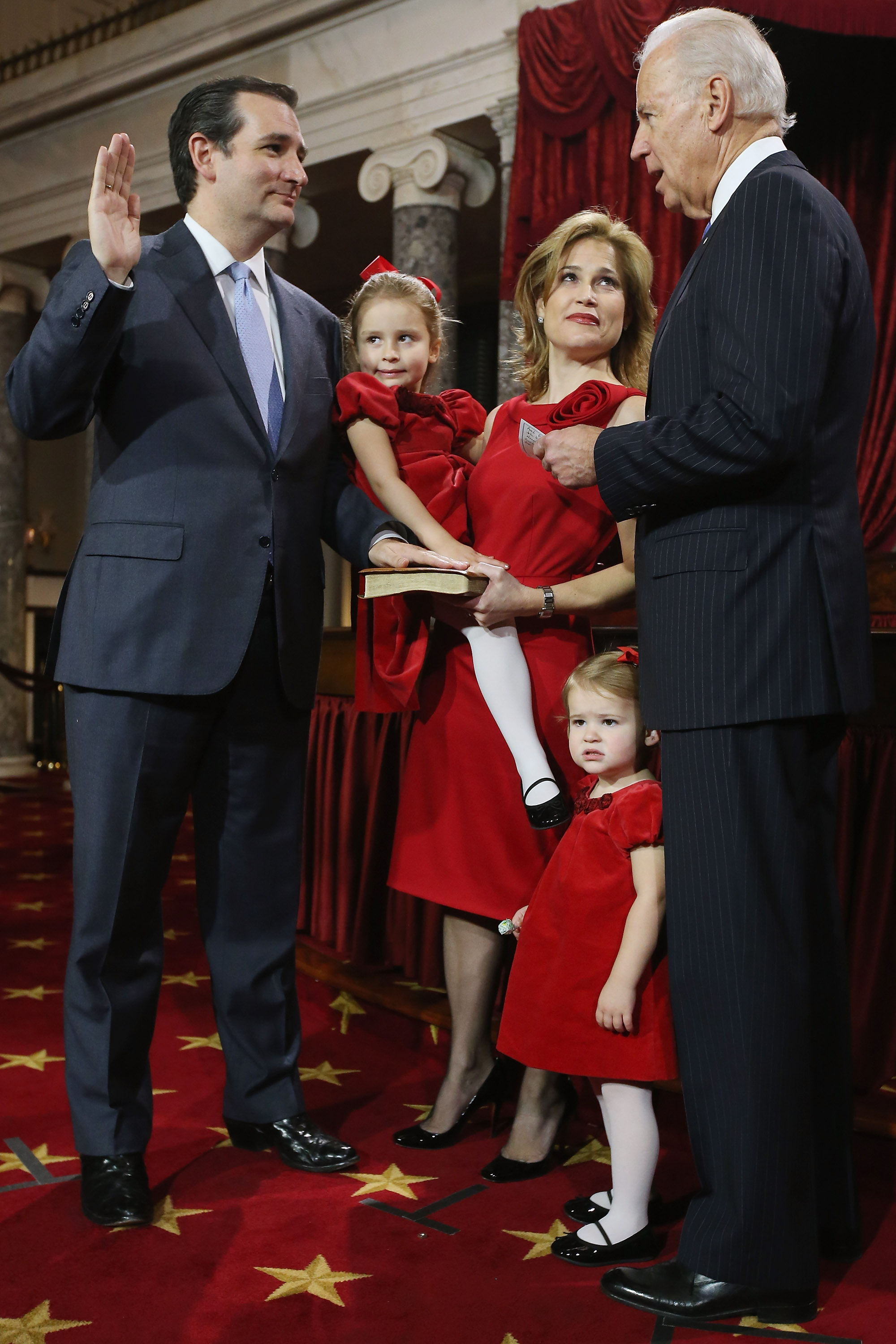 Sen. Ted Cruz (R-TX) (L) participates in a reenacted swearing-in with his wife  Heidi Nelson Cruz, daughters Caroline and Catherine, and U.S. Vice President Joe Biden . (Getty)