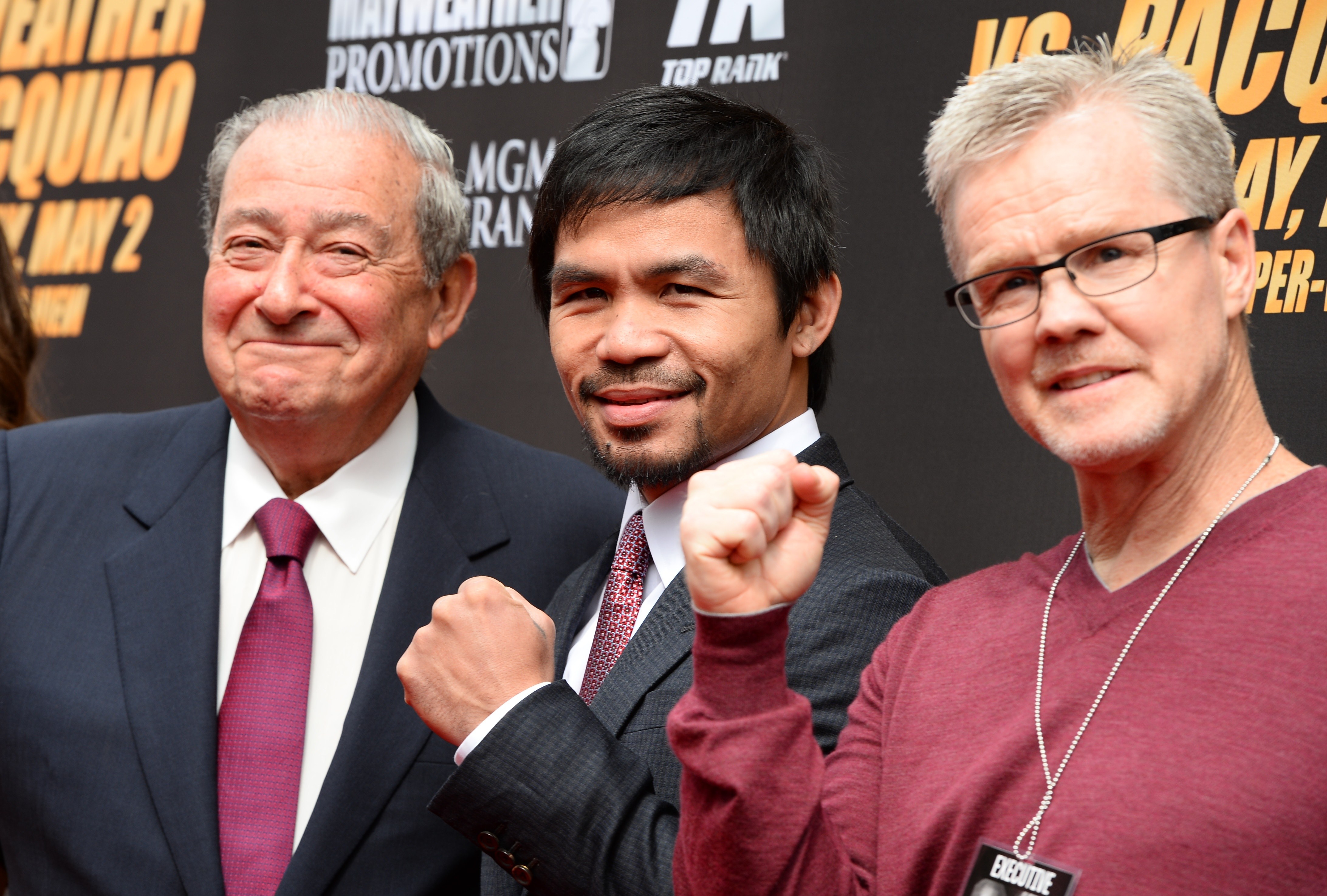 Manny Pacquiao (C), trainer Freddie Roach (L) and promoter Bob Arum arrive for a joint press conference with Floyd Mayweather Jr. (Getty)