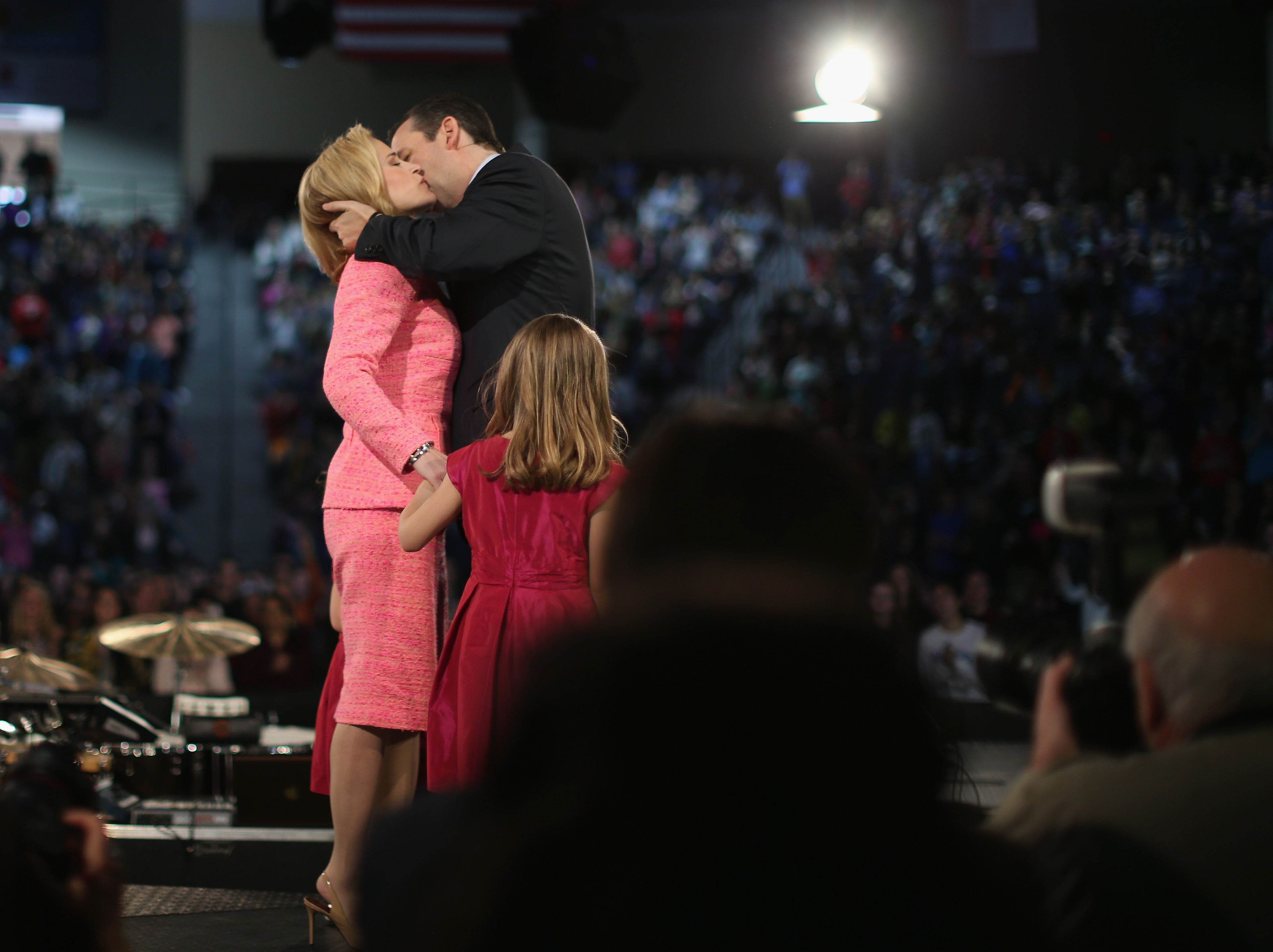 Sen. Ted Cruz (R-TX) (C) kisses his wife Heidi Cruz while standing with their daughter, six-year-old Caroline Cruz, after to speaking to a crowd gathered at Liberty University to announce his presidential candidacy March 23, 2015. (Getty)