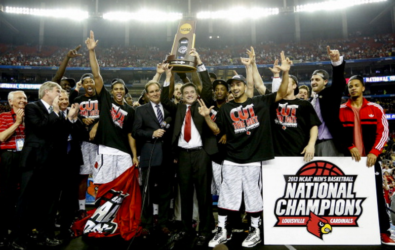 Louisville Cardinals head coach Rick Pitino celebrates with his team after defeating Michigan, 82-76, and winning the NCAA Men's Basketball Championship at the Georgia Dome in Atlanta, Georgia, Monday, April 8, 2013. (Getty)