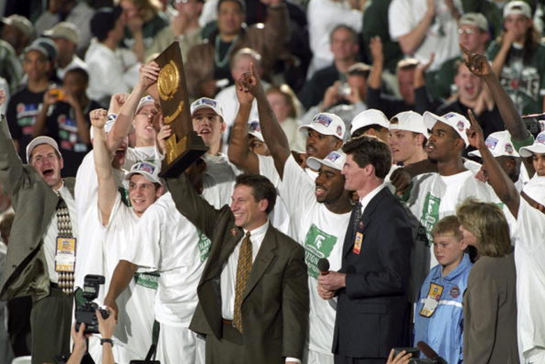 NCCA Final Four: Michigan State coach Tom Izzo victorious with team and NCAA National Championship trophy after winning game vs Florida. Indianapolis, IN 4/3/2000 (Getty)