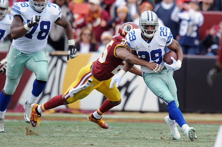 Running back DeMarco Murray #29 of the Dallas Cowboys runs with the ball while free safety Ryan Clark #25 of the Washington Redskins tries to tackle him in the second quater during a NFL football game at FedExField on December 28, 2014 in Landover. Maryland. (Getty)