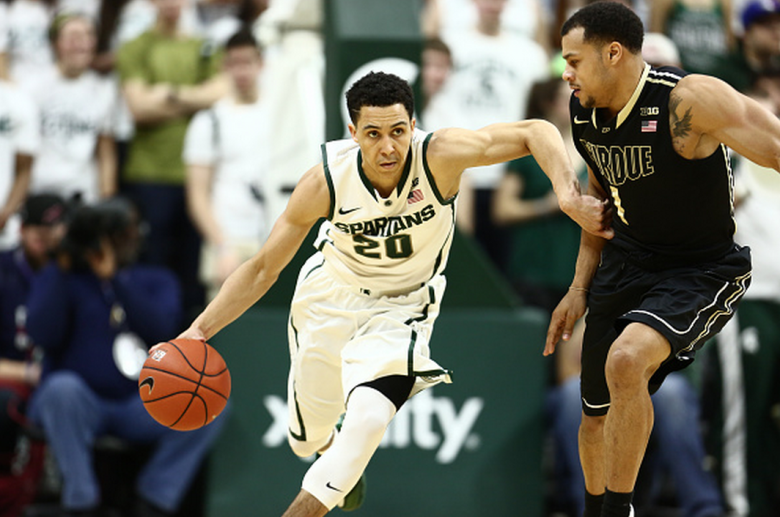 Travis Trice #20 of the Michigan State Spartans dribbles the ball during the game against Bryson Scott #1 of the Purdue Boilermakers at the Breslin Center on March 4, 2015 in East Lansing, Michigan. (Getty)