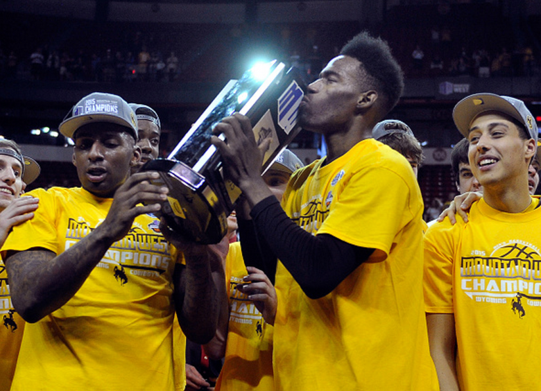 Derek Cooke Jr. #11 of the Wyoming Cowboys kisses the championship trophy after the Cowboys defeated the San Diego State Aztecs during the championship game of the Mountain West Conference basketball tournament at the Thomas & Mack Center on March 14, 2015 in Las Vegas, Nevada. Wyoming won 45-43. (Getty)