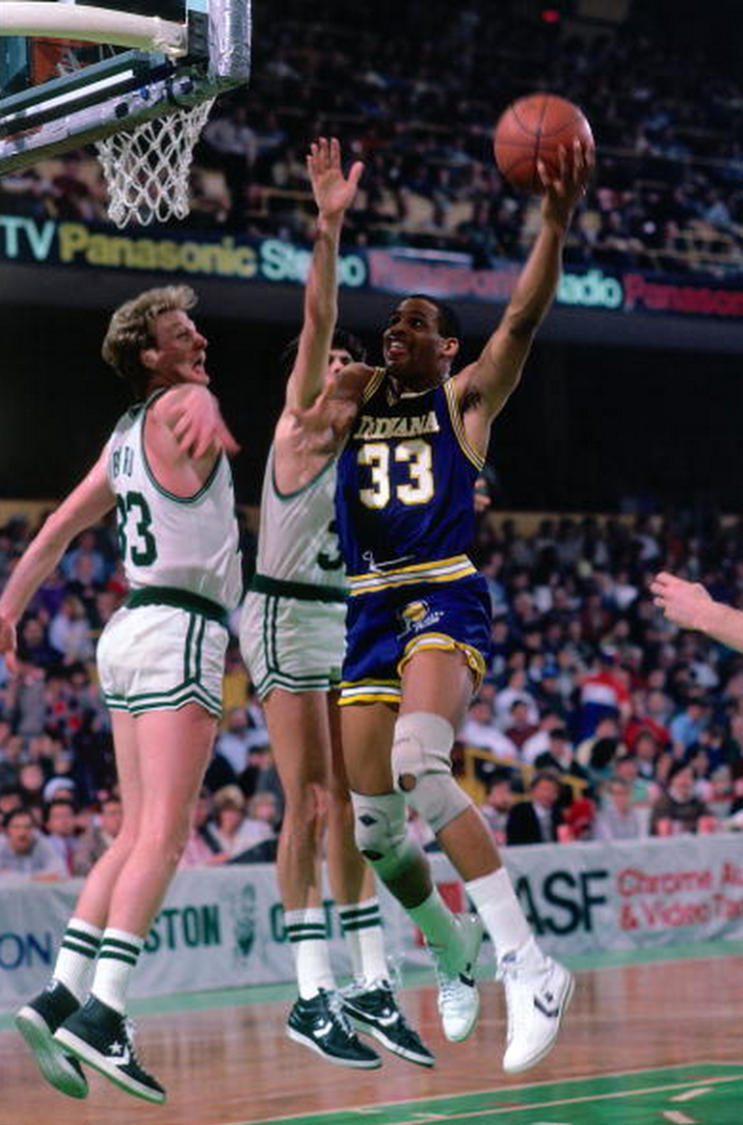 1985: Clark Kellogg #33 of the Indiana Pacers shoots against Larry Bird #33 of the Boston Celtics during a game played in 1985 at the Boston Garden in Boston, Massachusetts. NOTE TO USER: User expressly acknowledges and agrees that, by downloading and or using this photograph, User is consenting to the terms and conditions of the Getty Images License Agreement. Mandatory Copyright Notice: Copyright 1985 NBAE (Getty)