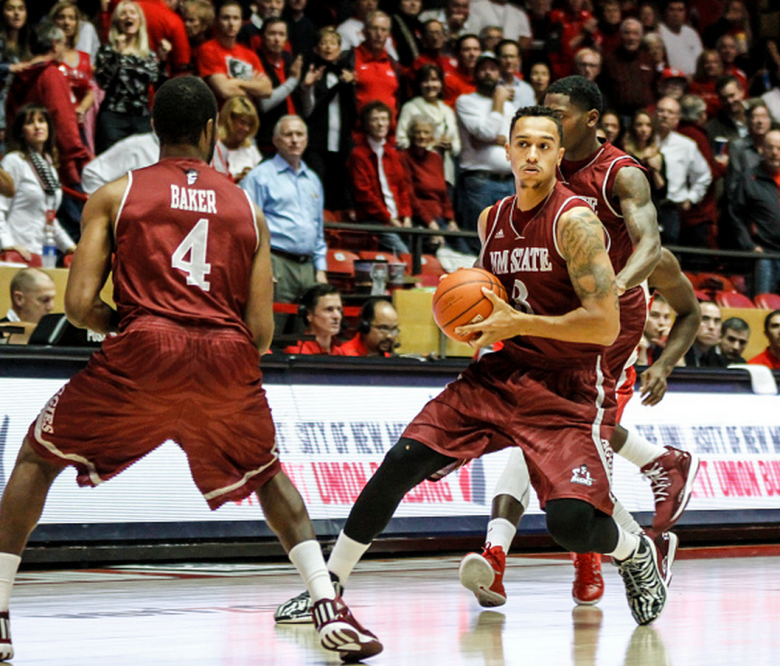 Remi Barry #3 of the NMSU Aggies prepares to pass the ball to teammate Ian Baker #4 during their game against the UNM Lobos at The WisePies Arena aka the Pit on December 3, 2014 in Albuquerque, New Mexico. New Mexico won 62-47. (Getty)