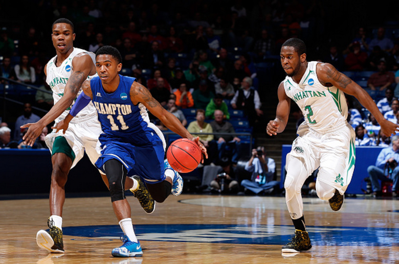 Deron Powers #11 of the Hampton Pirates brings the ball up the floor as Tyler Wilson #2 of the Manhattan Jaspers defends during the first round of the 2015 NCAA Men's Basketball Tournament at UD Arena on March 17, 2015 in Dayton, Ohio. (Getty)