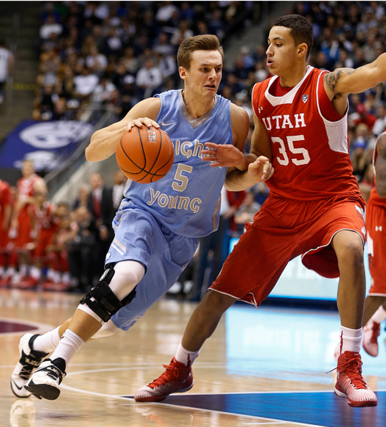 Kyle Collinsworth #5 of the Brigham Young Cougars drives on Kyle Kuzma #35 of the Utah Utes during the second half of an college basketball game December 10, 2014 in Provo, Utah. Utah defeated BYU 65-61. (Getty)