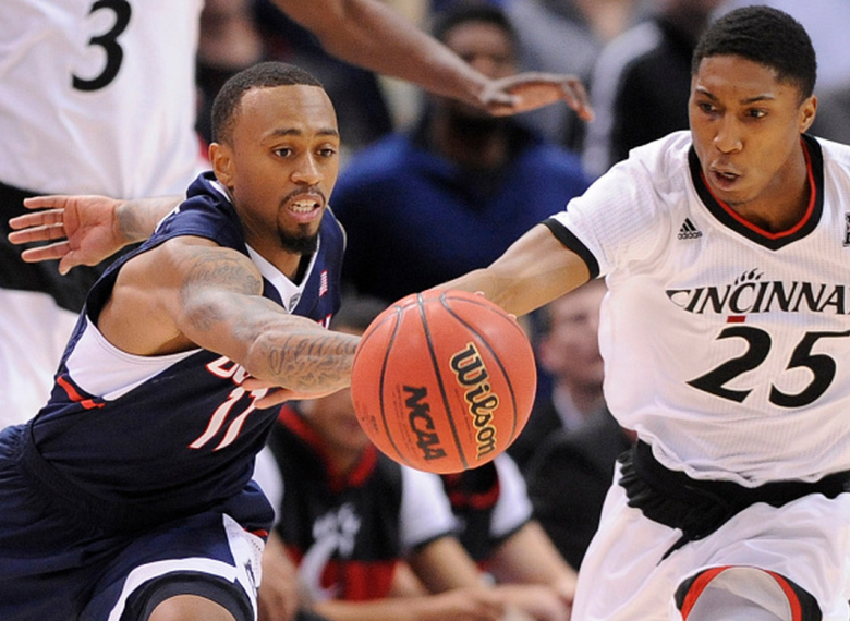 Connecticut's Ryan Boatright (11) challenges Cincinnati's Kevin Johnson (25) for a loose ball in the quarterfinals of the AAC Tournament at XL Center in Hartford, Conn., on Friday, March 13, 2014. UConn advanced, 57-54. (Getty)