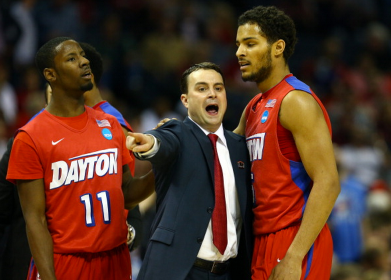 Head coach Archie Miller speaks with Devin Oliver #5 of the Dayton Flyers during a regional semifinal of the 2014 NCAA Men's Basketball Tournament against the Stanford Cardinal at the FedExForum on March 27, 2014 in Memphis, Tennessee. (Getty)