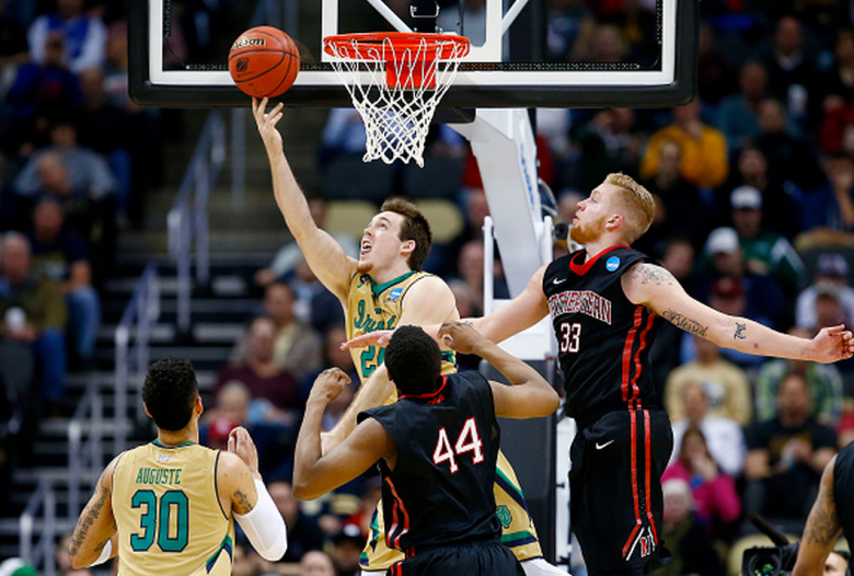 Pat Connaughton #24 of the Notre Dame Fighting Irish shoots against the defense of Zach Stahl #33 and Reggie Spencer #44 of the Northeastern Huskies in the second half during the second round of the 2015 NCAA Men's Basketball Tournament at Consol Energy Center on March 19, 2015 in Pittsburgh, Pennsylvania. (Getty)